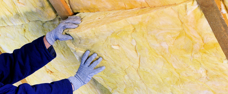 HVAC expert installing attic insulation. | Attic Insulation Gainesville, FL