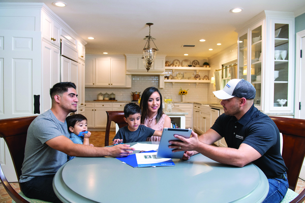 A technician explaining to homeowners | AC Repair in Gainesville, FL